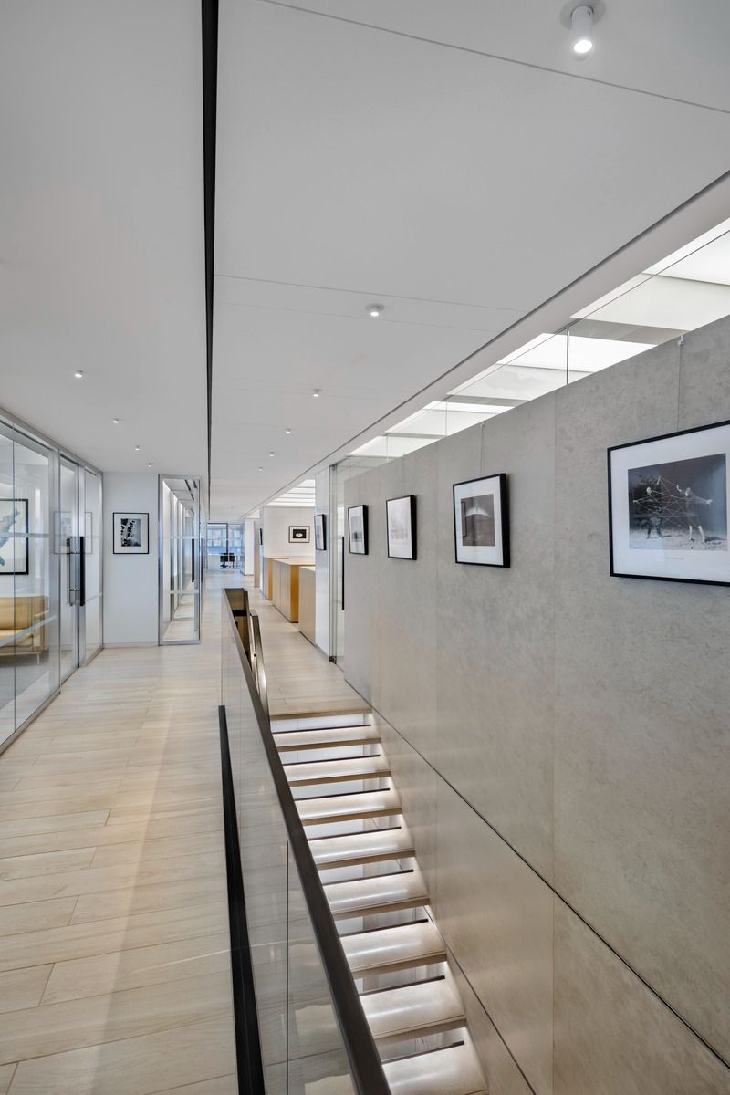 Modern stairway lined with framed black-and-white photographs